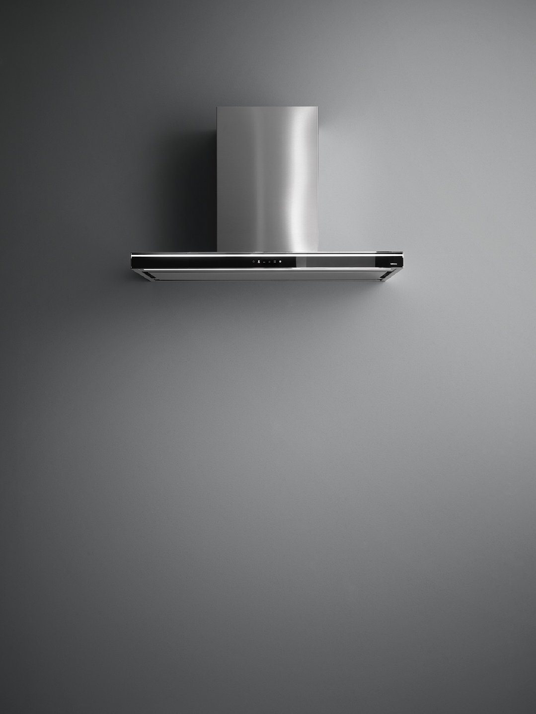 Stainless steel wall canopy rangehood mounted on a dark grey wall