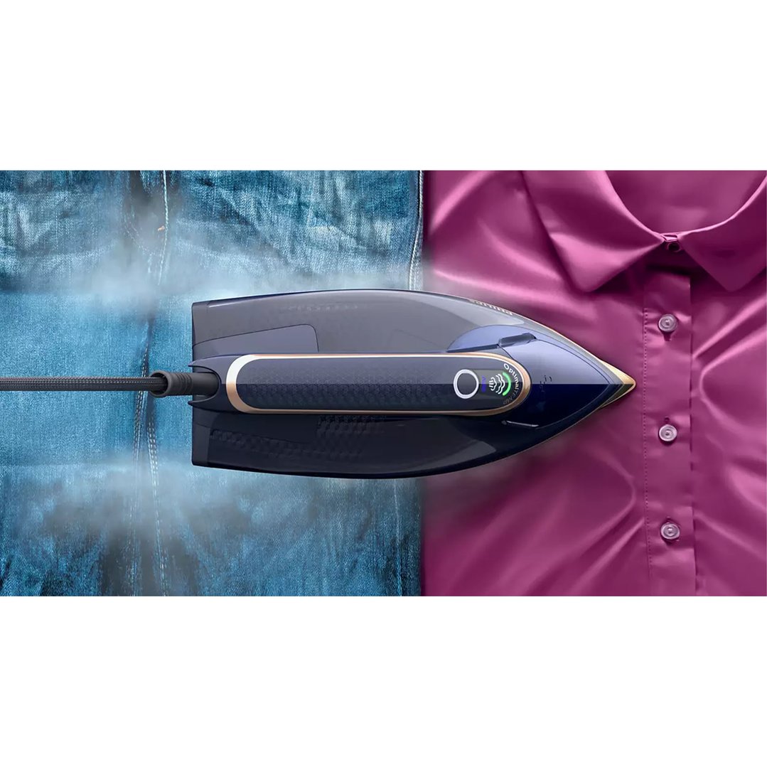 Steam iron on a blue denim garment and a pink shirt