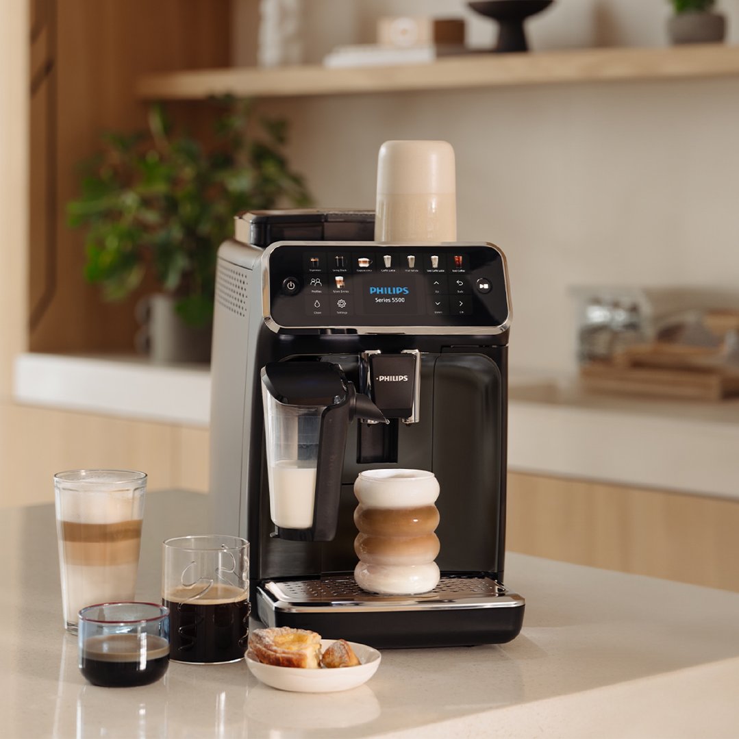 Philips Series 5500 Fully Automatic Espresso Machine on a kitchen counter with coffee drinks