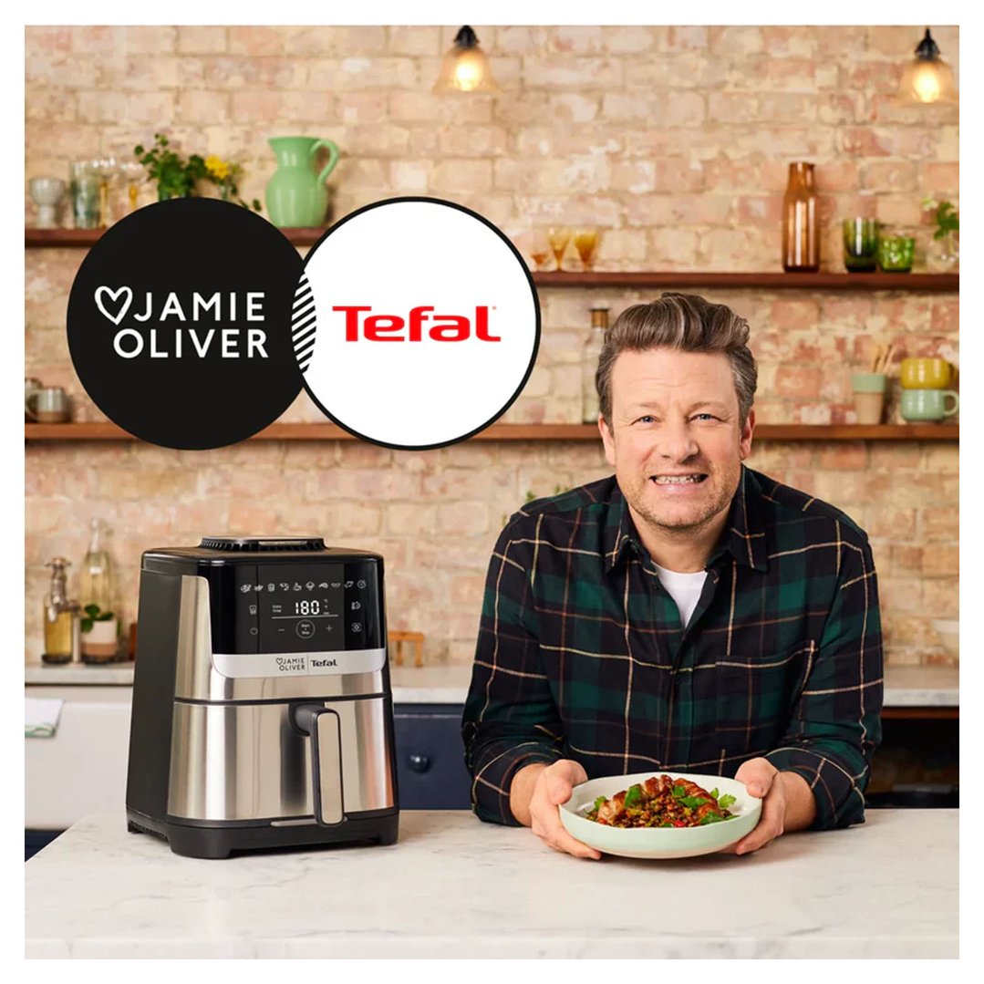 Jamie Oliver holding a bowl of food next to a Tefal air fryer