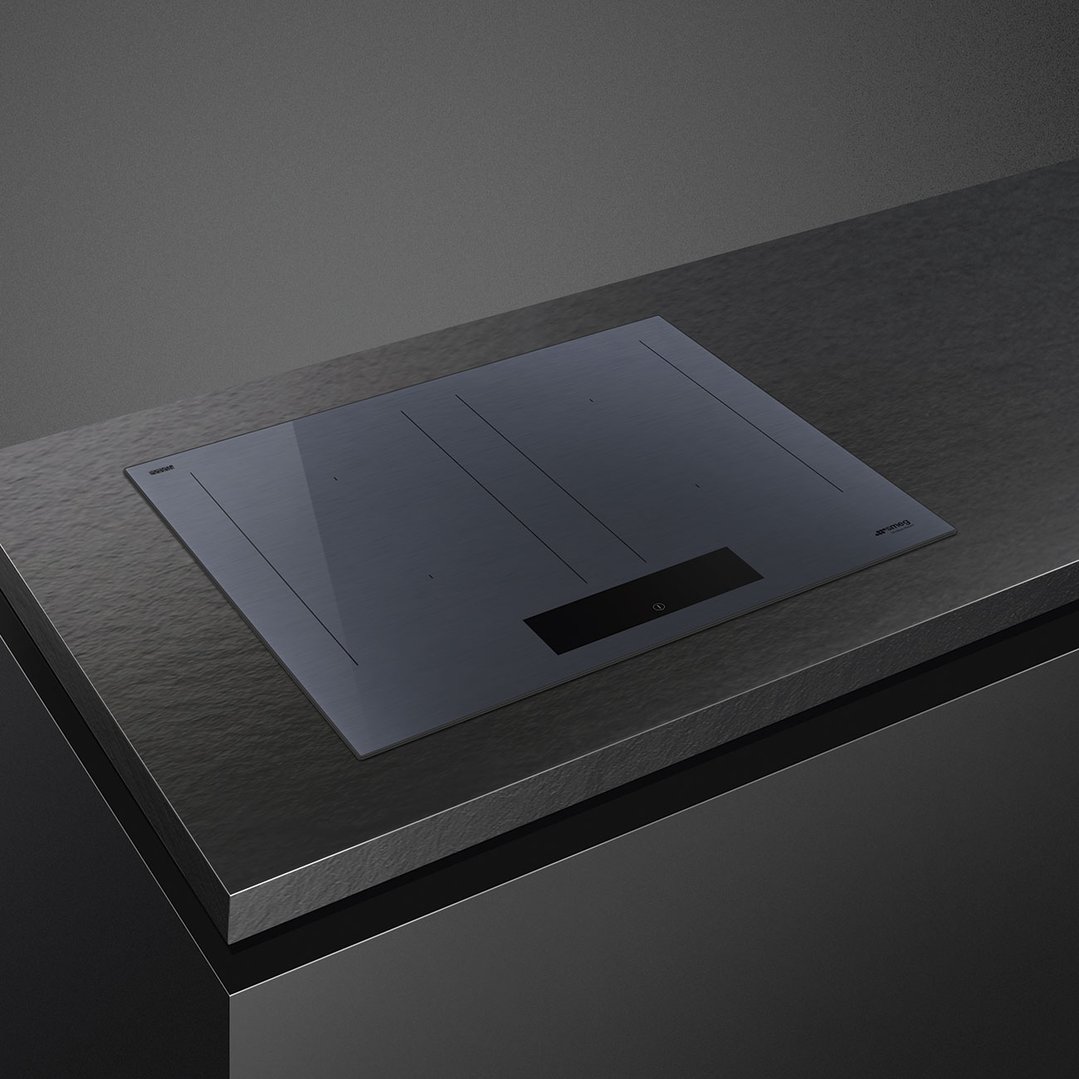SMEG induction cooktop built into a dark grey kitchen countertop