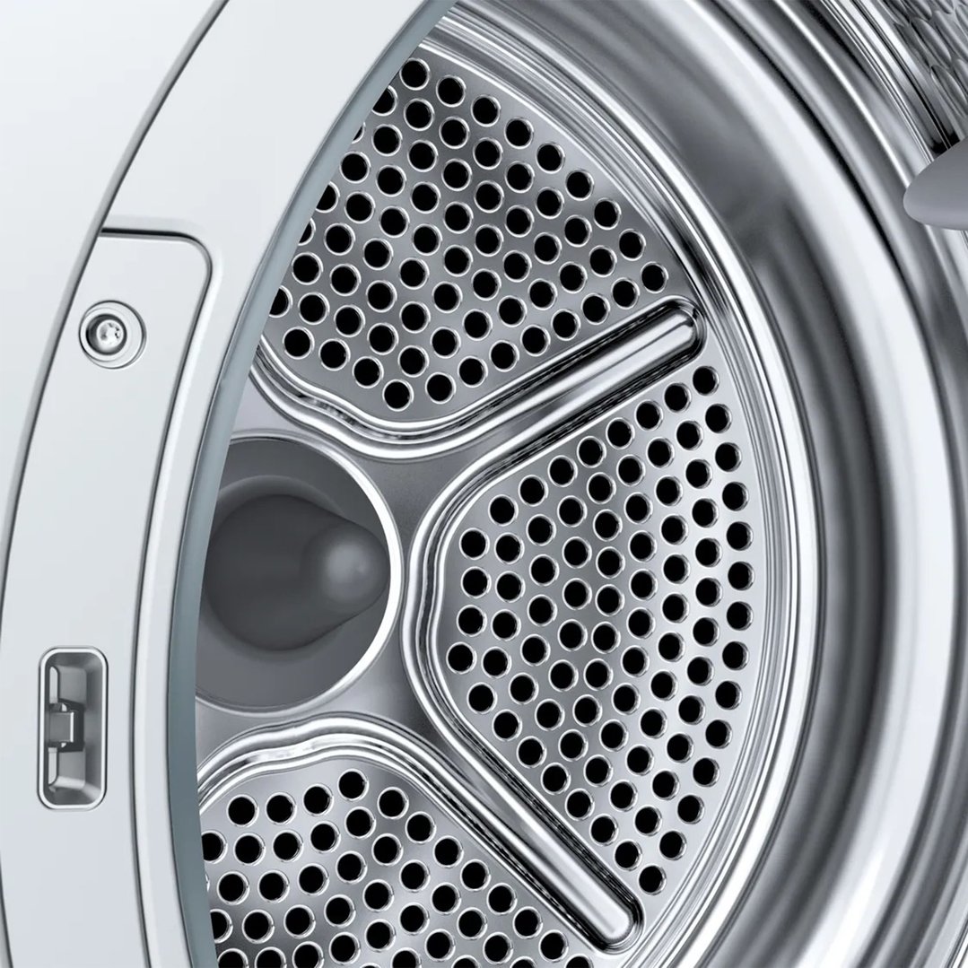 Close-up of the perforated metal drum inside a heat pump dryer