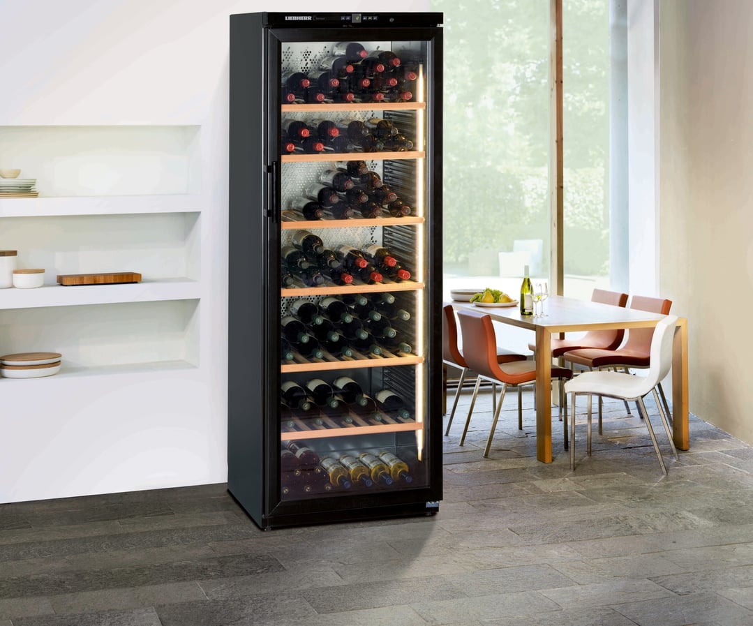 Tall black wine cabinet with glass door in a modern dining room