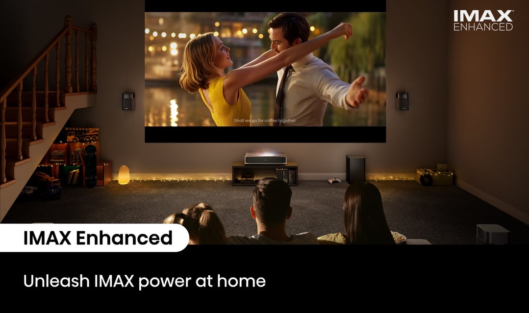 Family watching a movie projected onto a wall in a dimly lit room