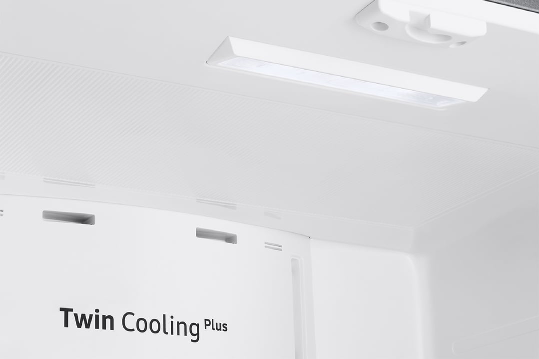 Interior of a refrigerator with a light and "Twin Cooling Plus" text
