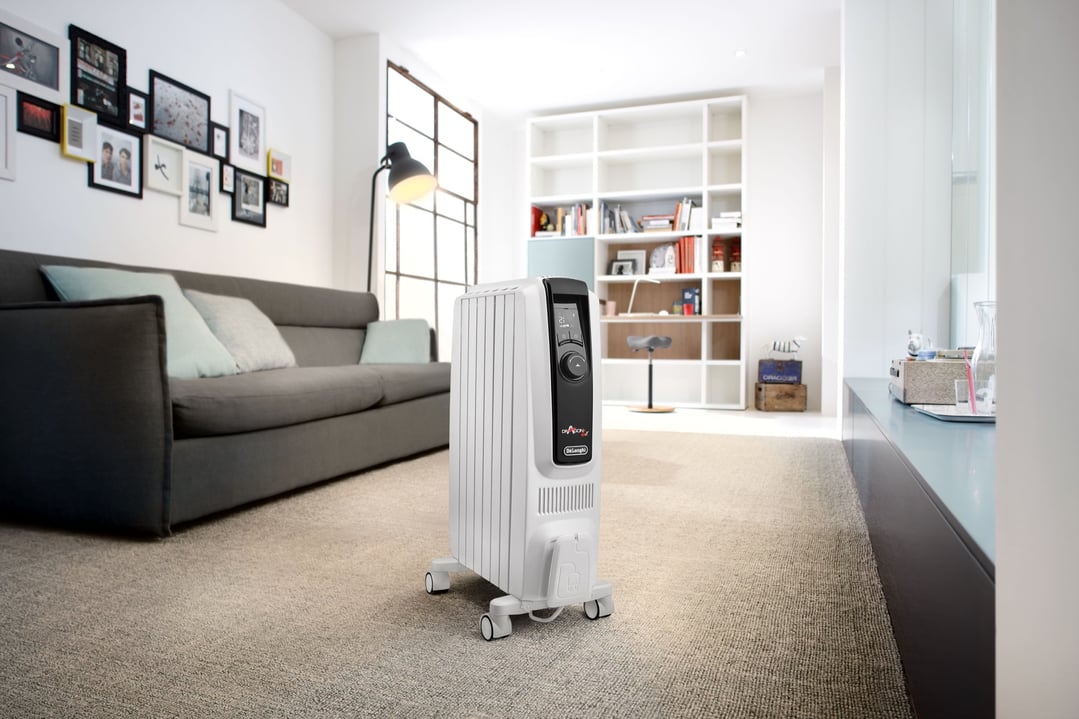 White oil column heater on carpet in a modern living room