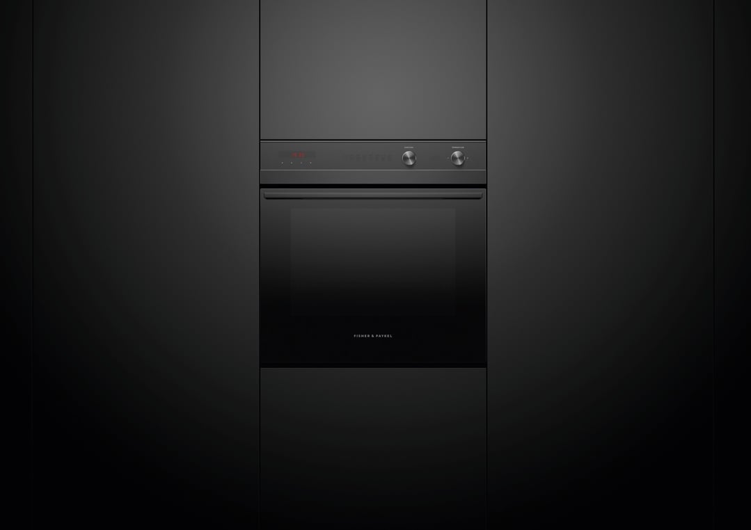 A black built-in oven with a digital display and two control knobs