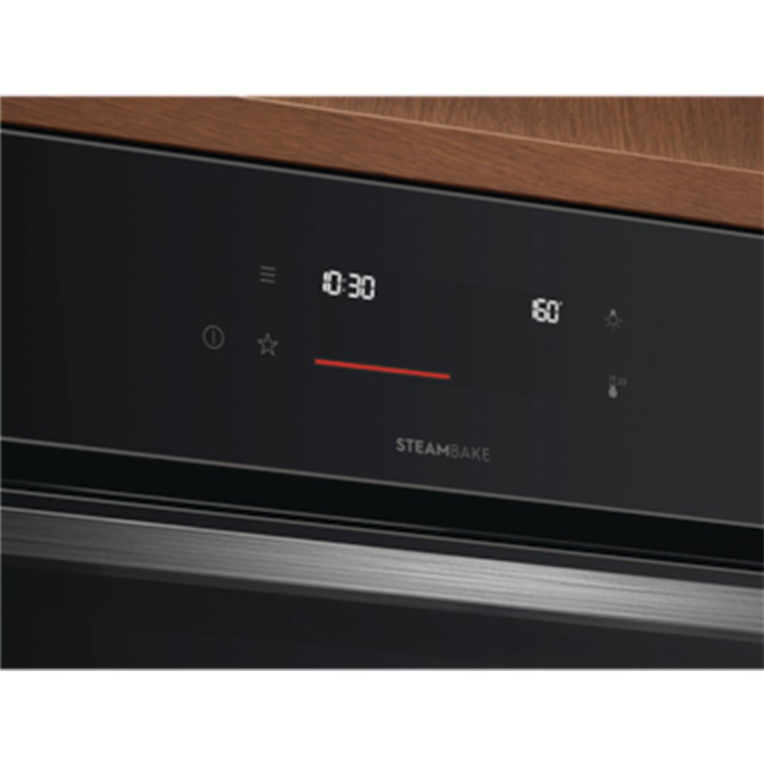 Close-up of an oven's control panel with a digital display showing 10:30