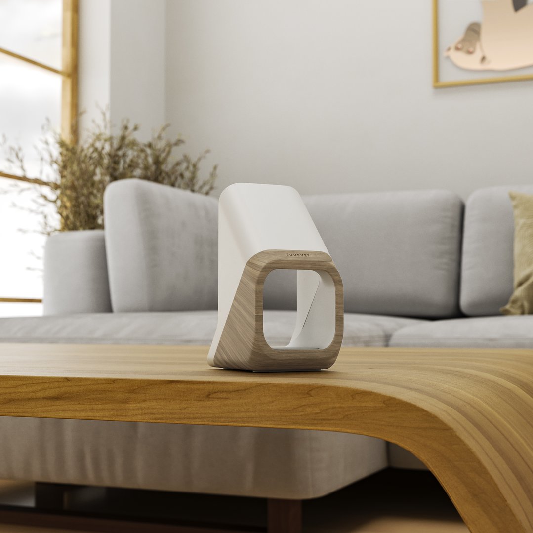 A NOVA 3-in-1 Fast Wireless Charging Station on a wooden coffee table