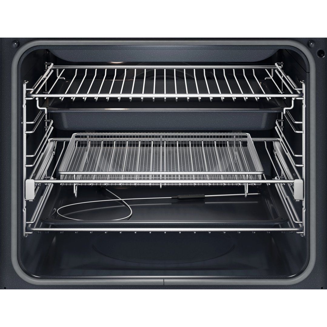 Interior view of an oven with racks, a wire basket, and a food probe