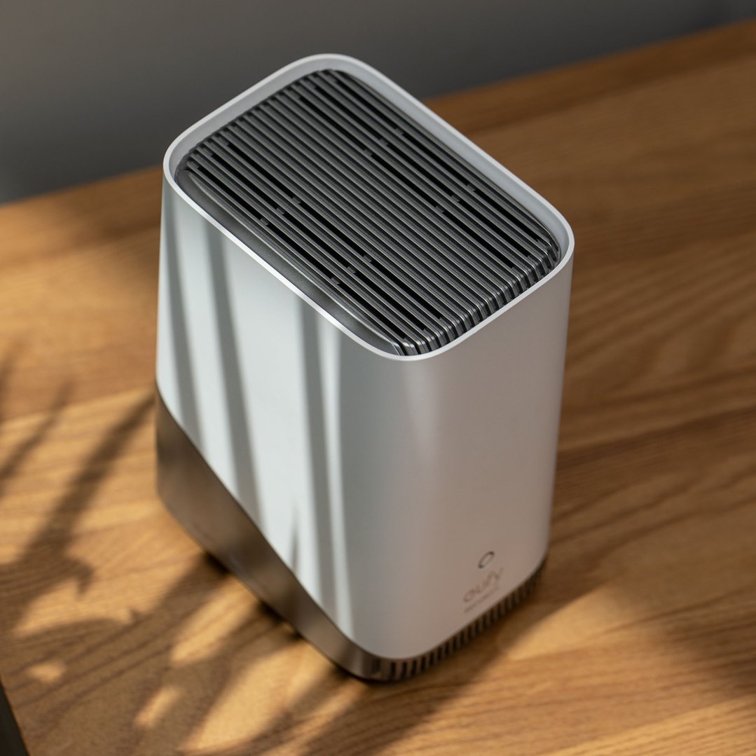 EUFY HomeBase 3 security camera hub on a wooden surface with shadows