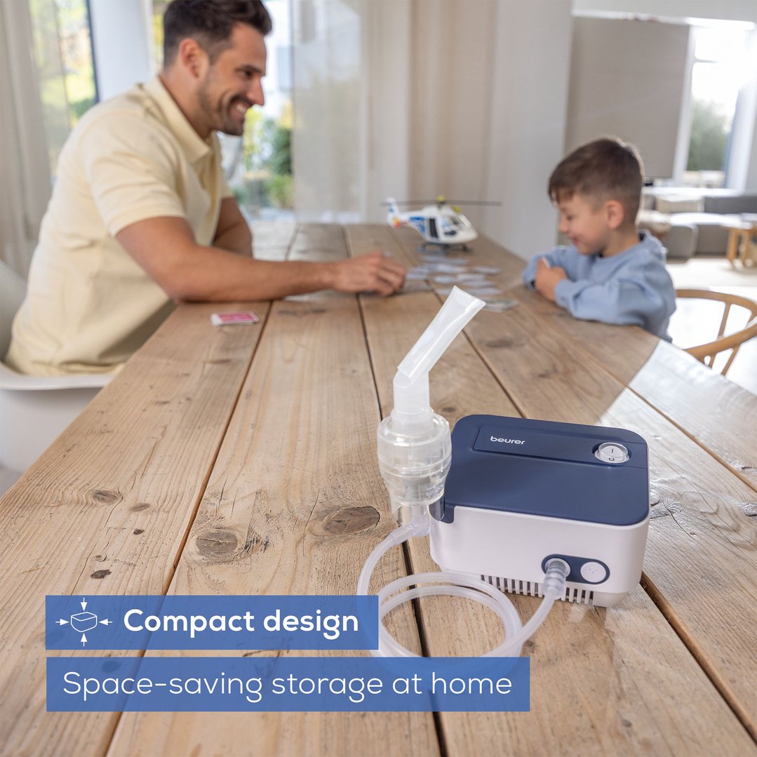 Nebuliser on a wooden table with a man and child in the background