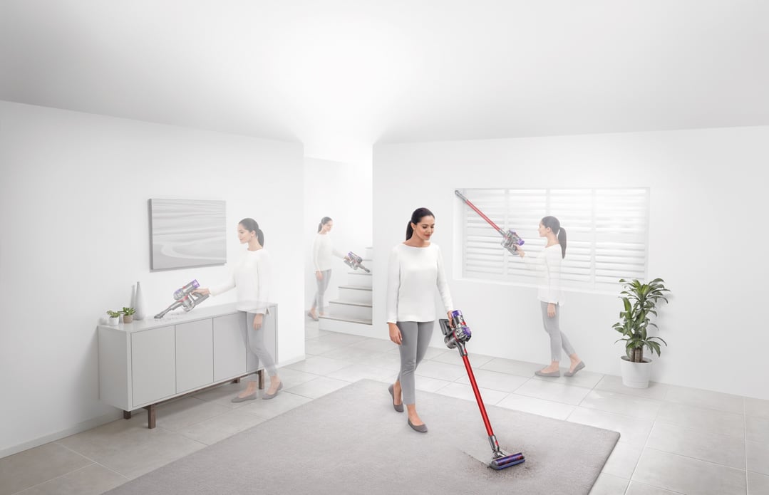 Woman using a Dyson V8 Origin handstick vacuum in multiple household settings