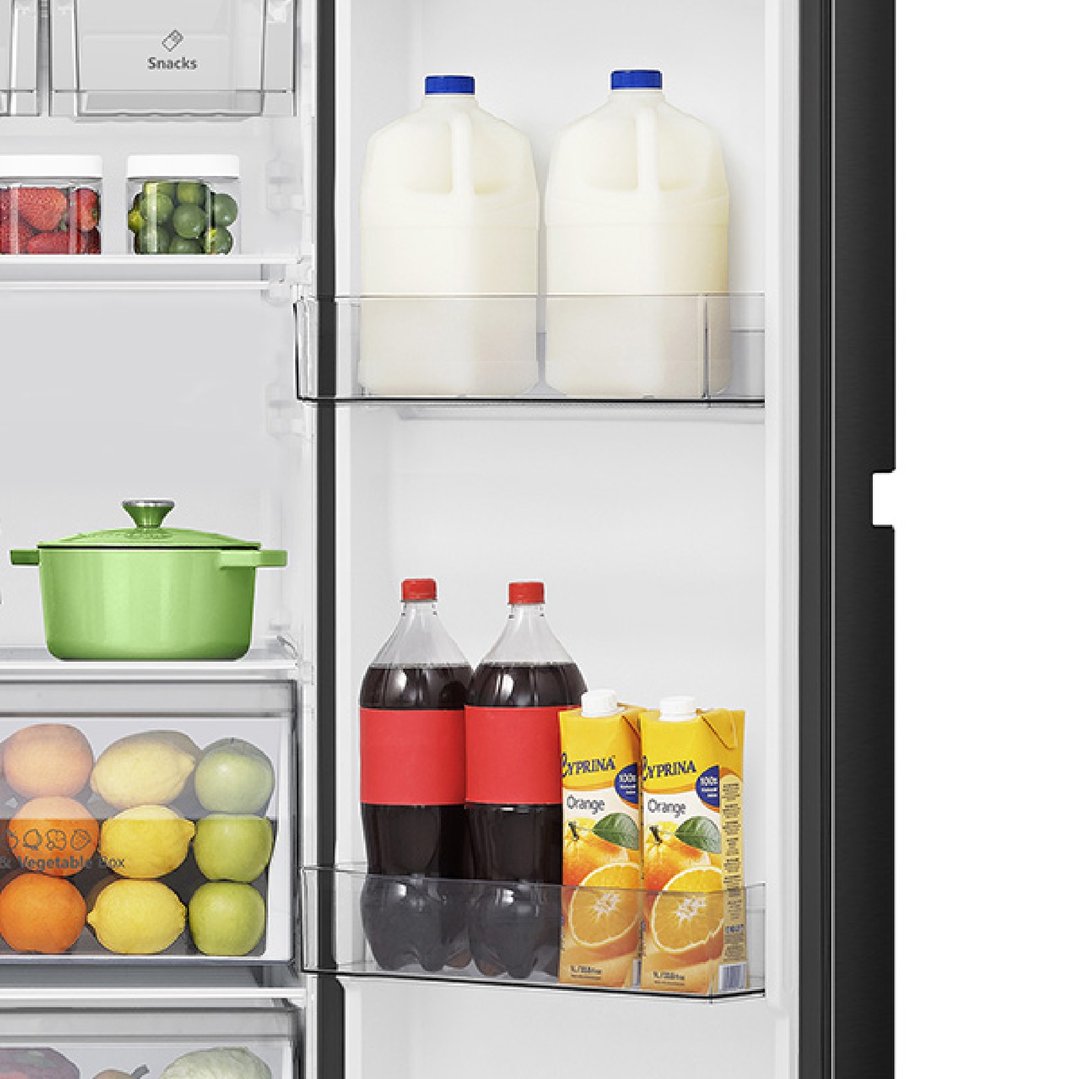 Open fridge door showing various food items and drinks on shelves and in drawers