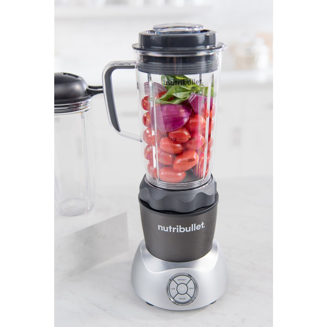 Nutribullet blender with tomatoes and onions in a kitchen setting