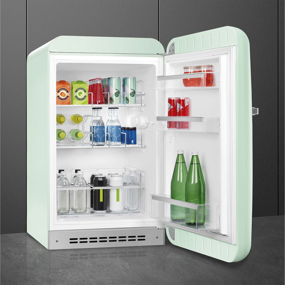 Pastel green SMEG refrigerator with door open, filled with drinks