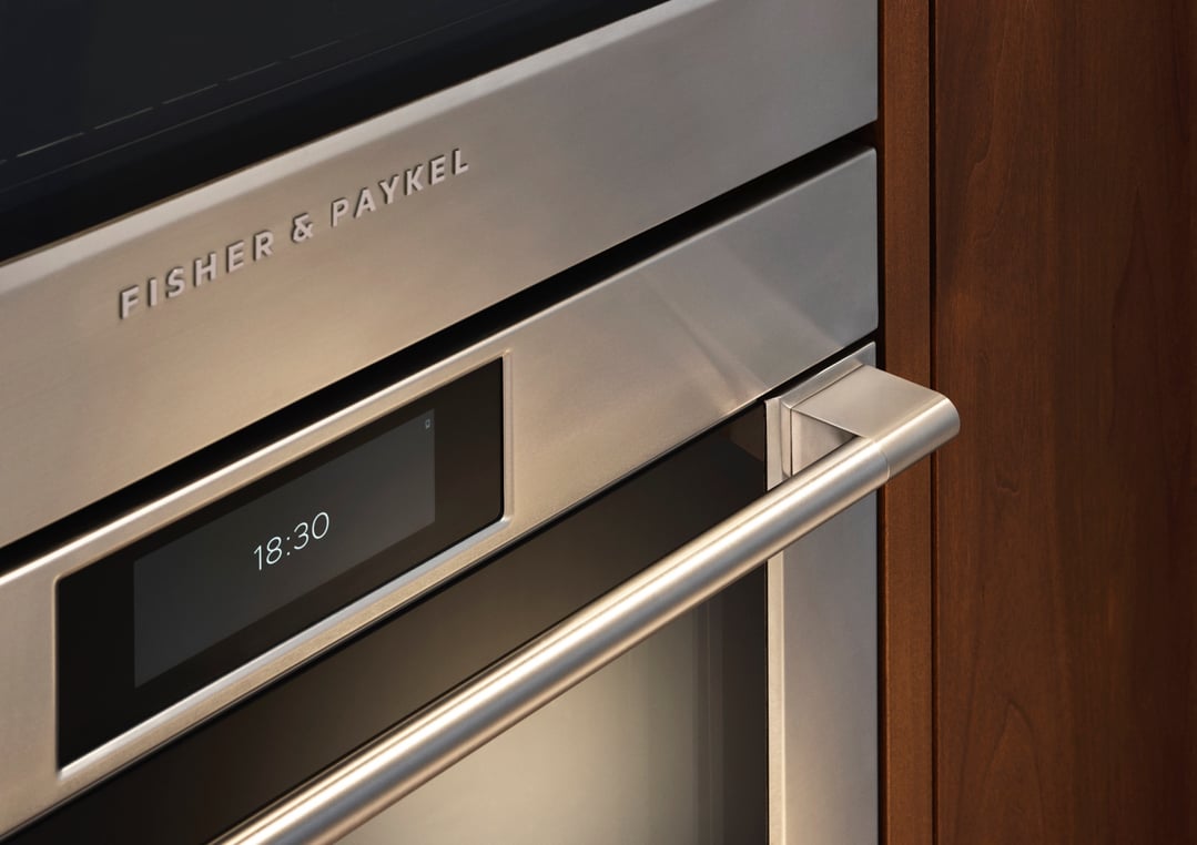 Close up of a stainless steel Fisher & Paykel oven with a digital display