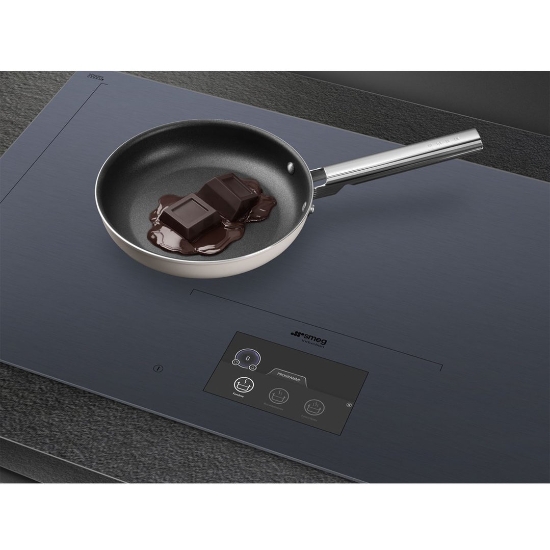 SMEG induction cooktop with a pan of melting chocolate on its surface