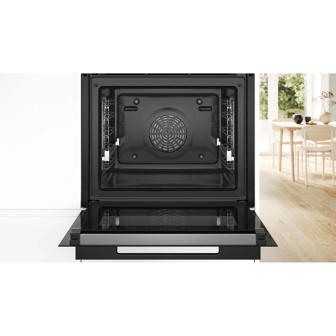 Open oven with interior visible, set in a modern kitchen environment