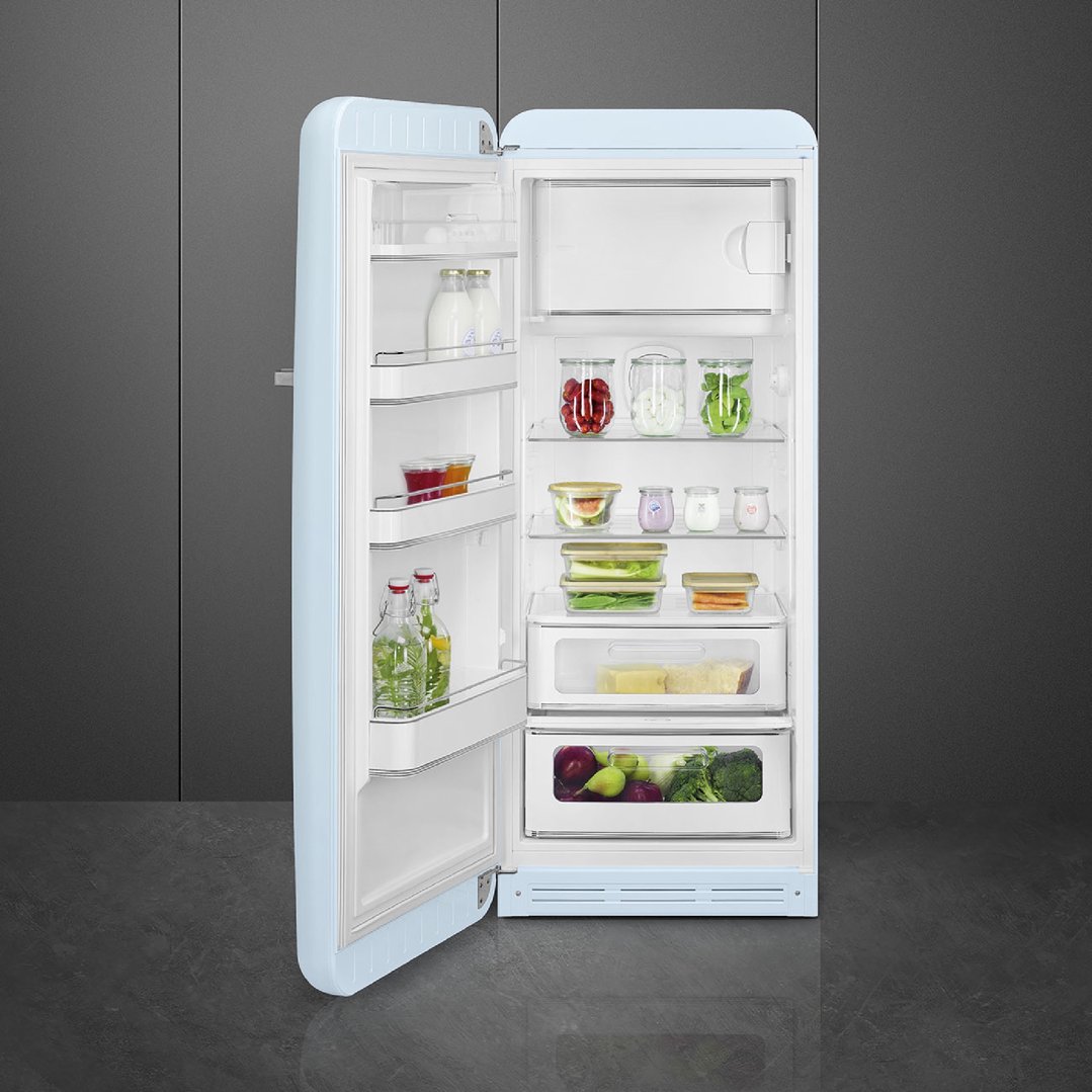 Pastel blue retro refrigerator with door open, filled with food items