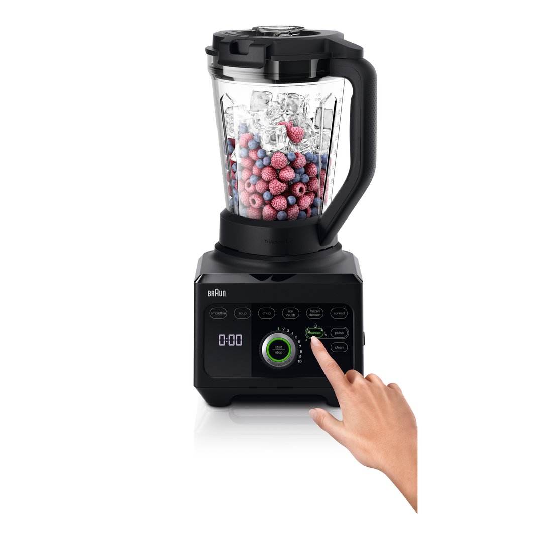 Hand pressing the manual button on a black Braun PowerBlend 9 Jug Blender