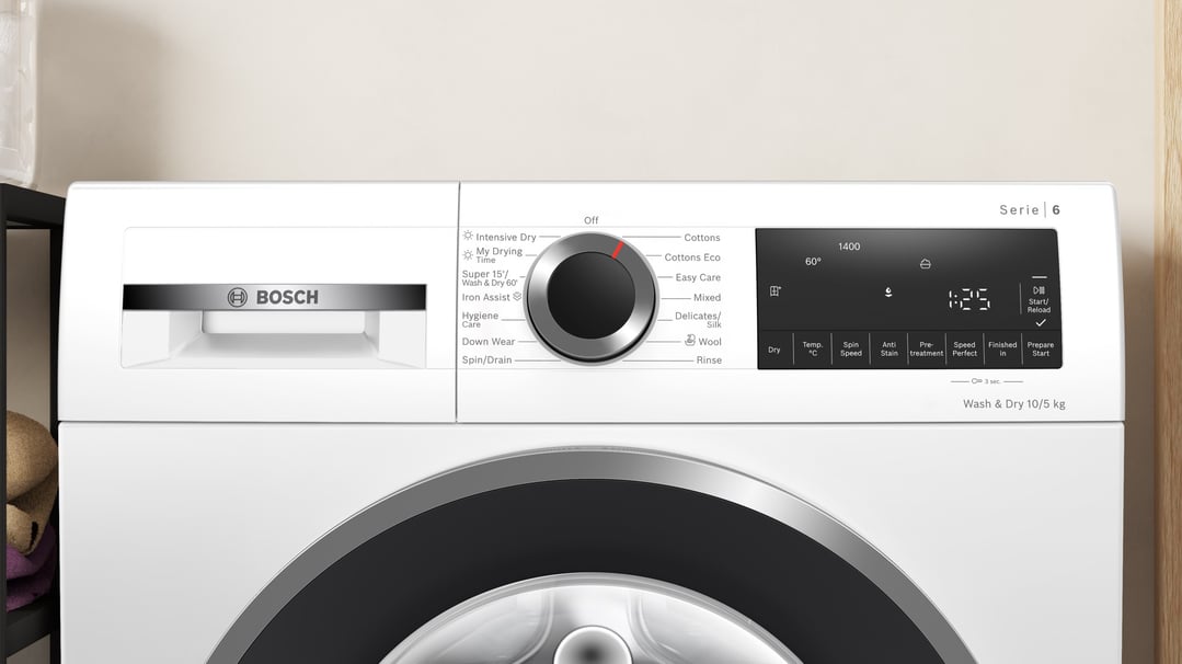 Close up of a white Bosch washer dryer combo in a room