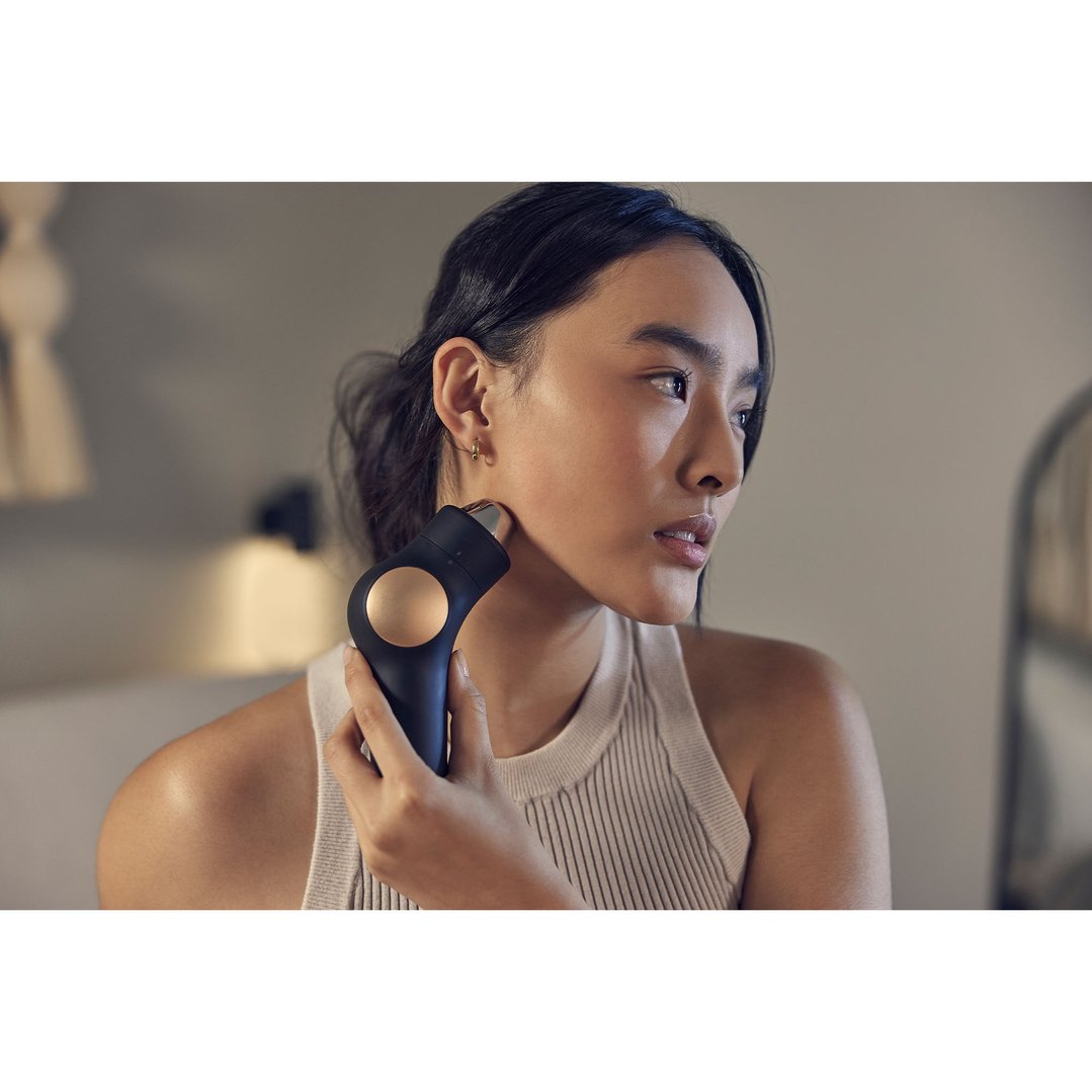 Woman using a TheraFace PRO Hot & Cold Rings on her jawline