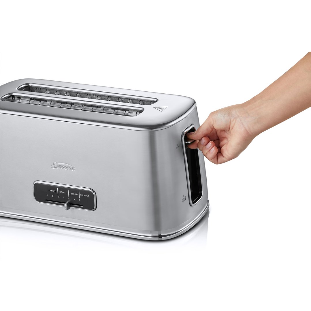 Hand pushing down the lever of a stainless steel toaster