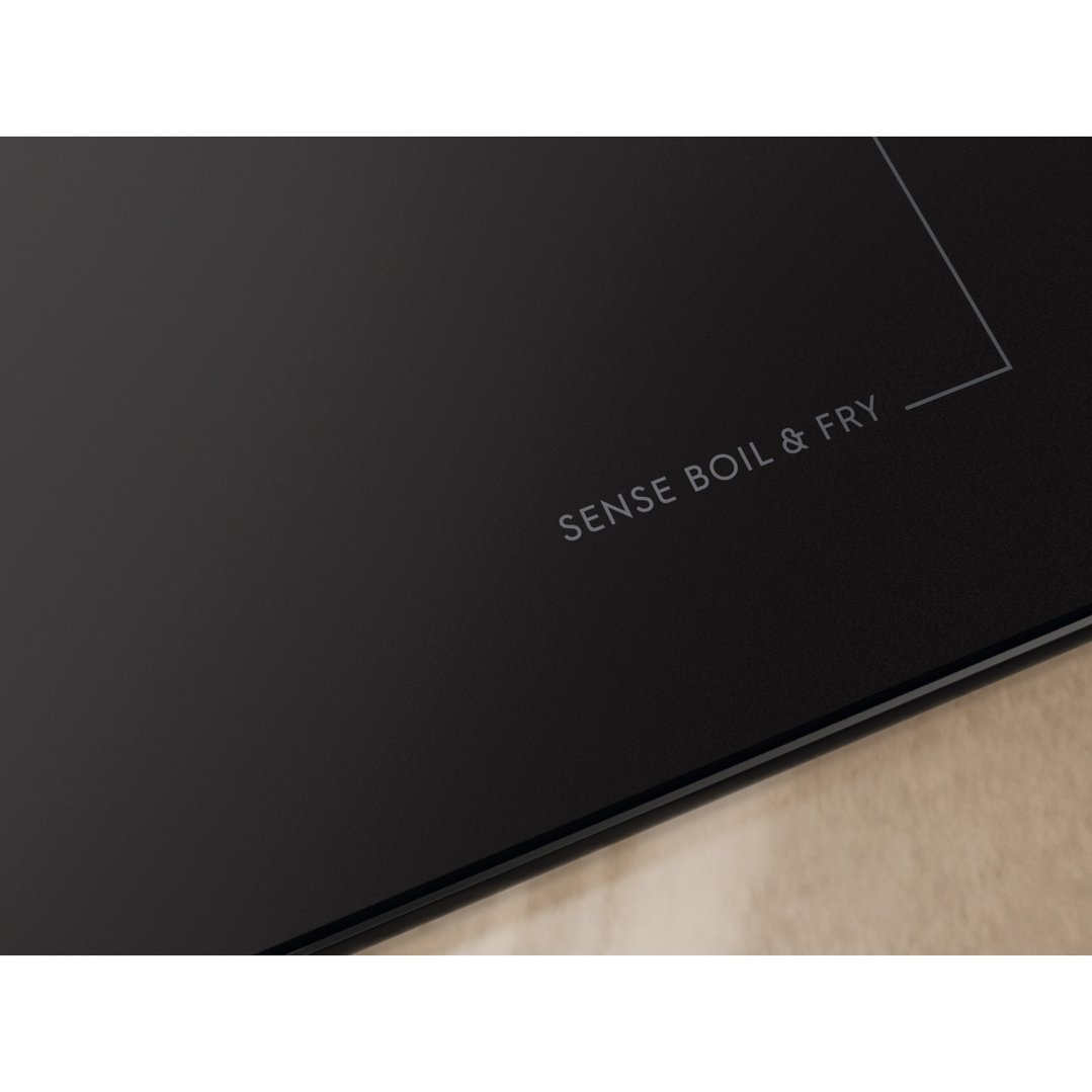 Close up of a black induction cooktop with "SENSE BOIL & FRY" text