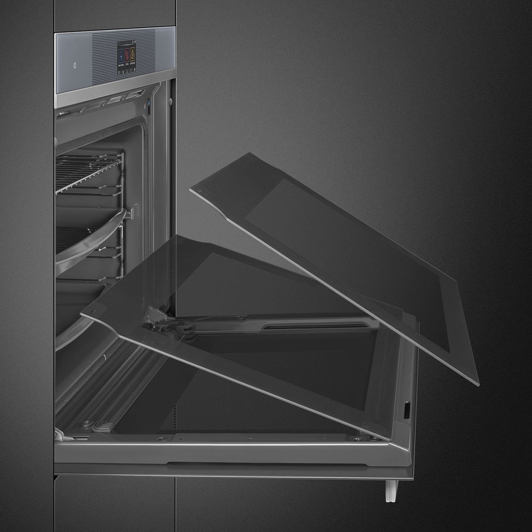 Close up of an oven with its door open, showing the interior