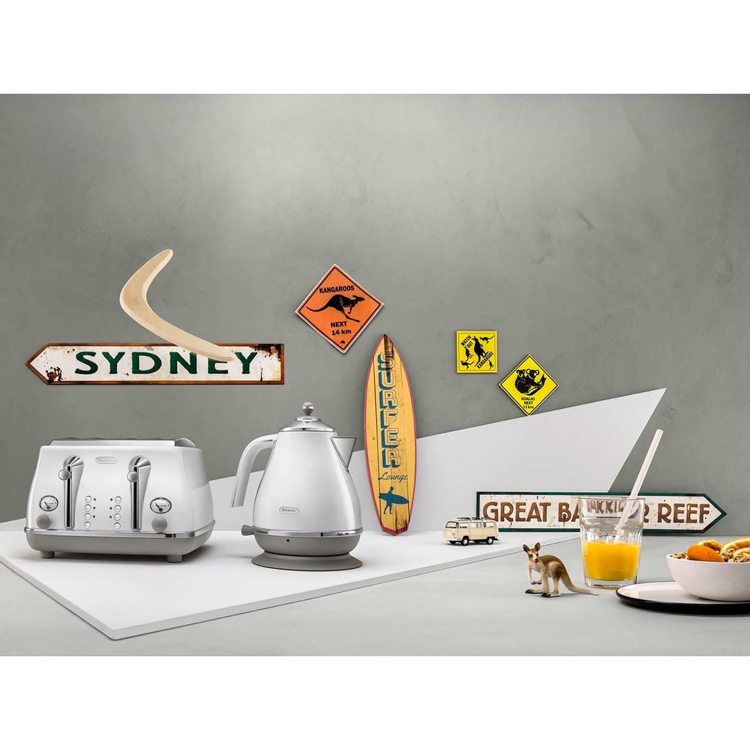 White toaster and kettle on a white surface with Australian-themed decor