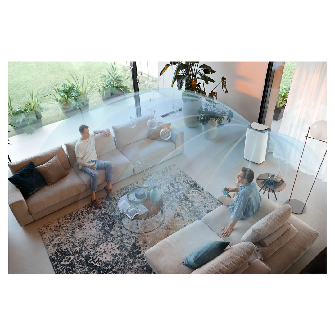 Two men relaxing on sofas in a living room with an air conditioner