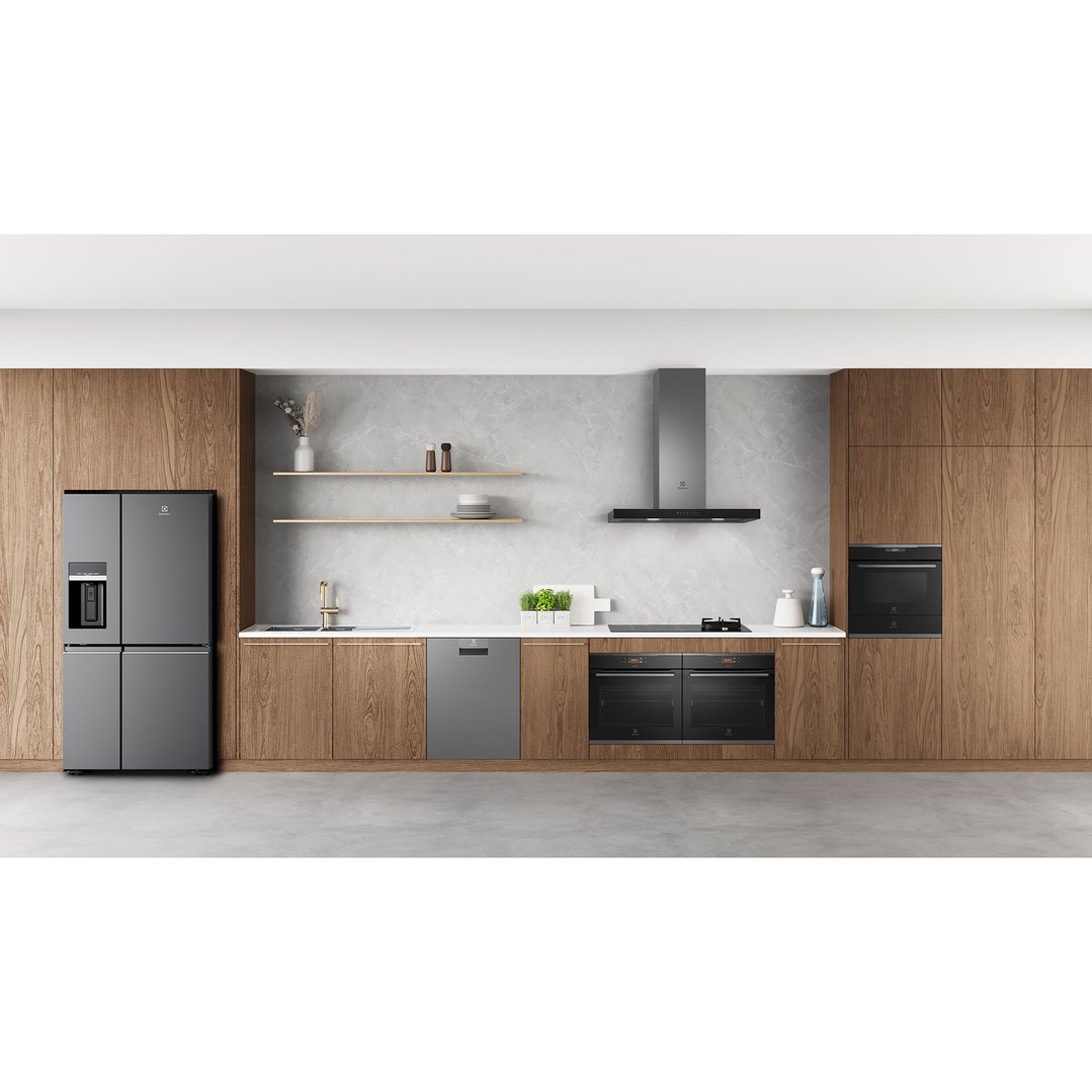Dark stainless steel oven built into a modern kitchen with wooden cabinets