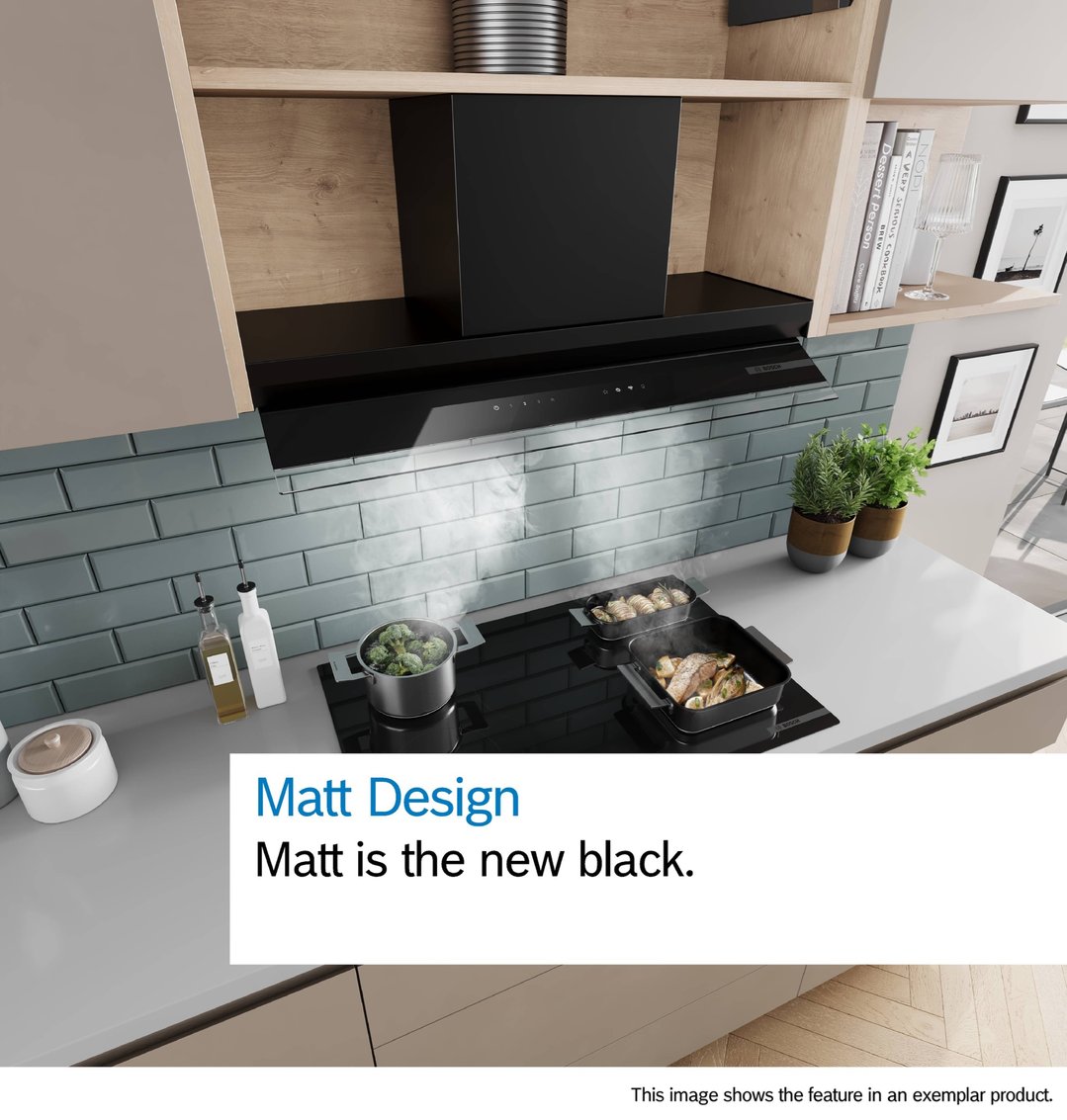 Integrated rangehood above a cooktop with pots and pans in a modern kitchen