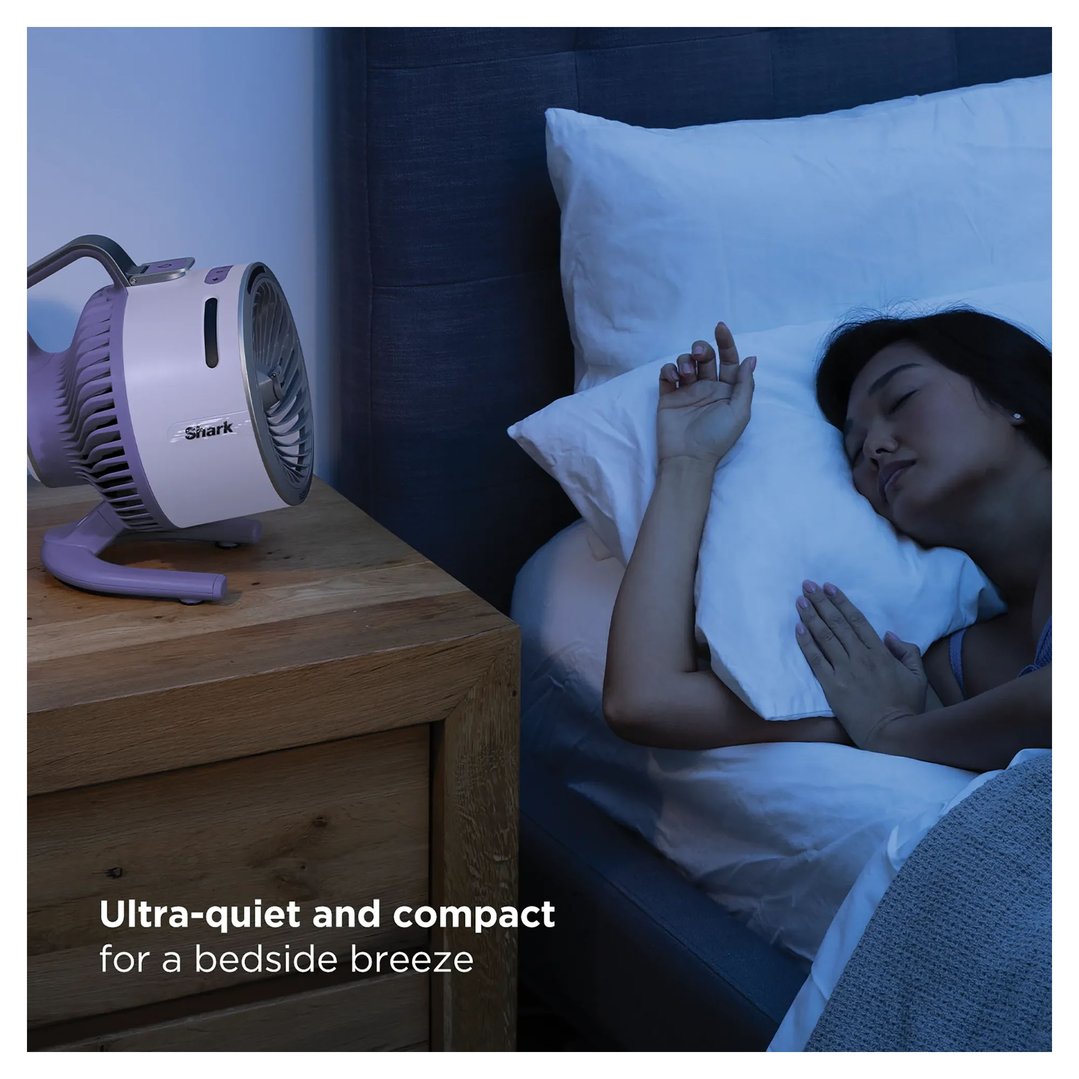 Lilac Shark fan on a bedside table next to a sleeping woman