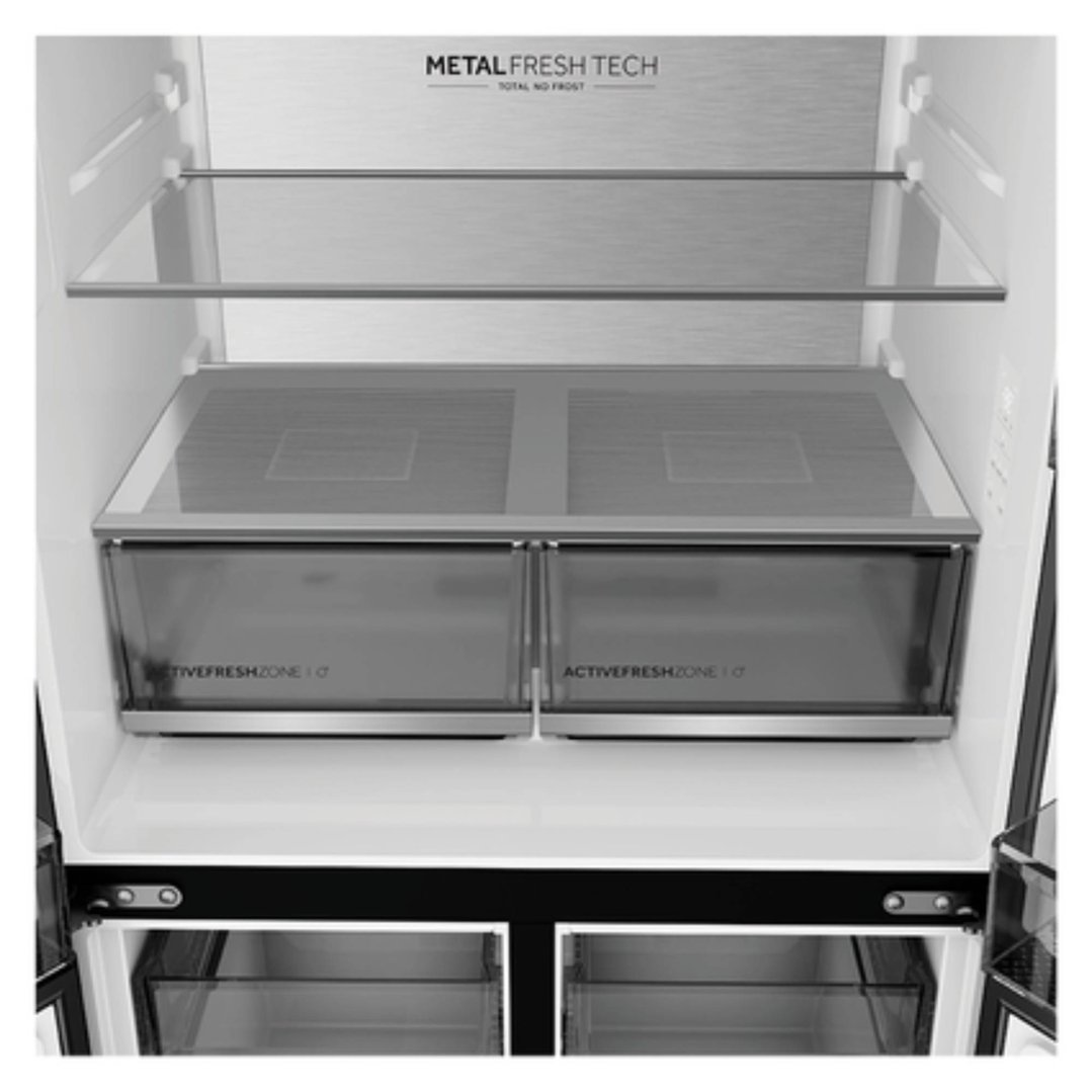 Interior view of a Haier refrigerator showing shelves and crisper drawers