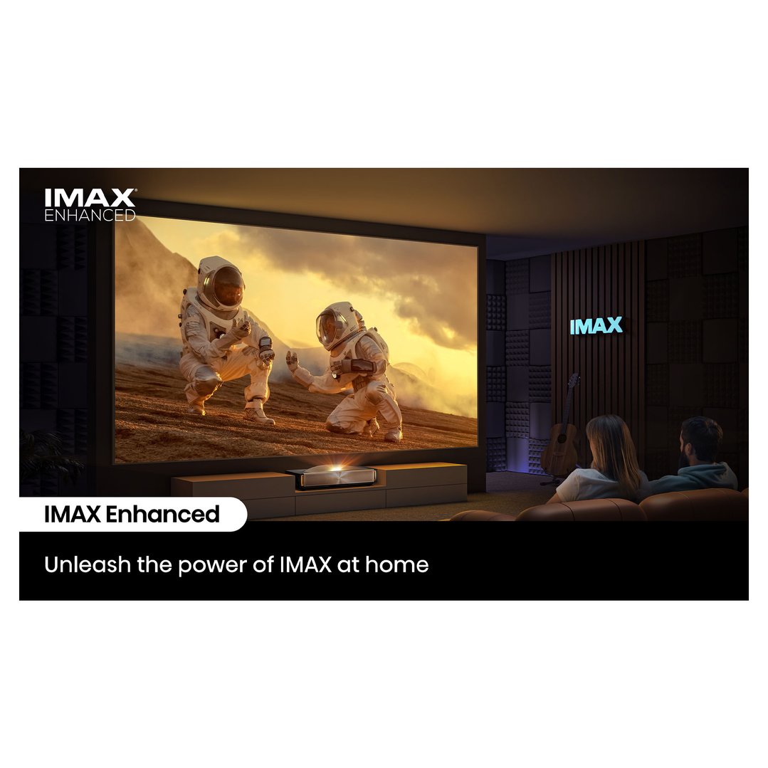 Projector displaying a movie on a large screen in a home theater with two people watching