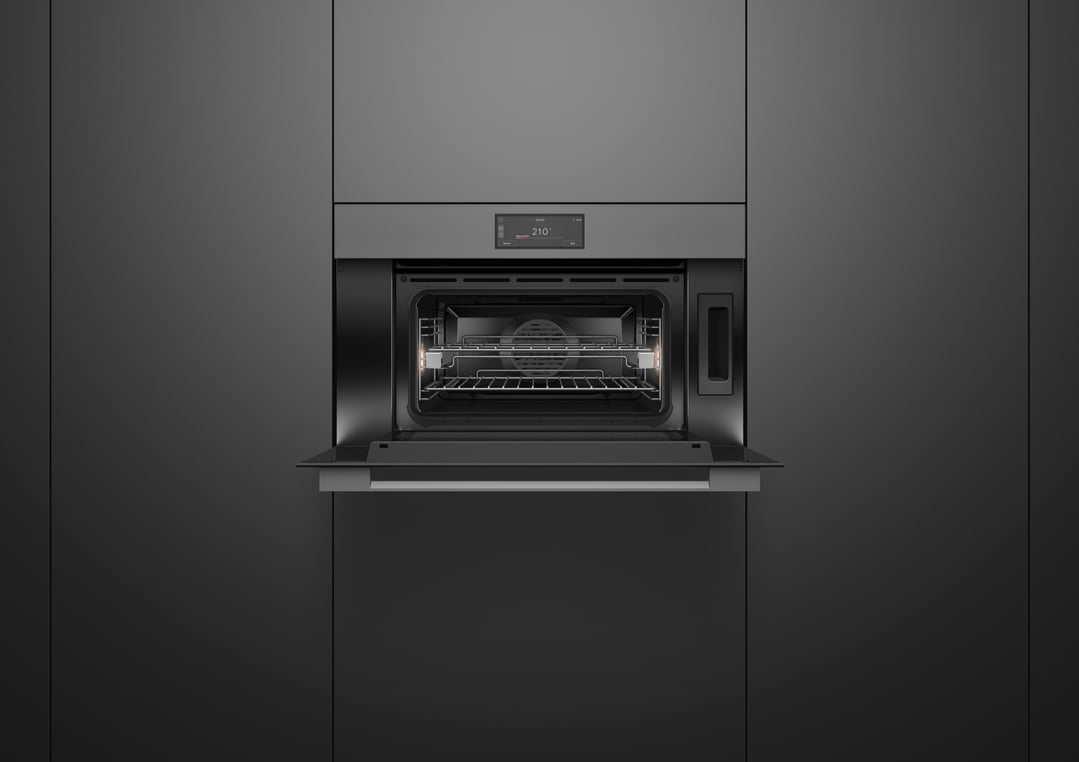 Built-in grey glass combi-steam oven with door open, showing interior racks and light
