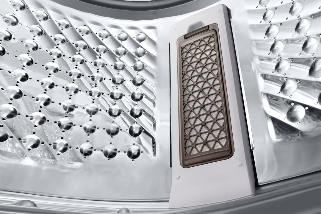 Close-up of the inside of a washing machine drum and lint filter