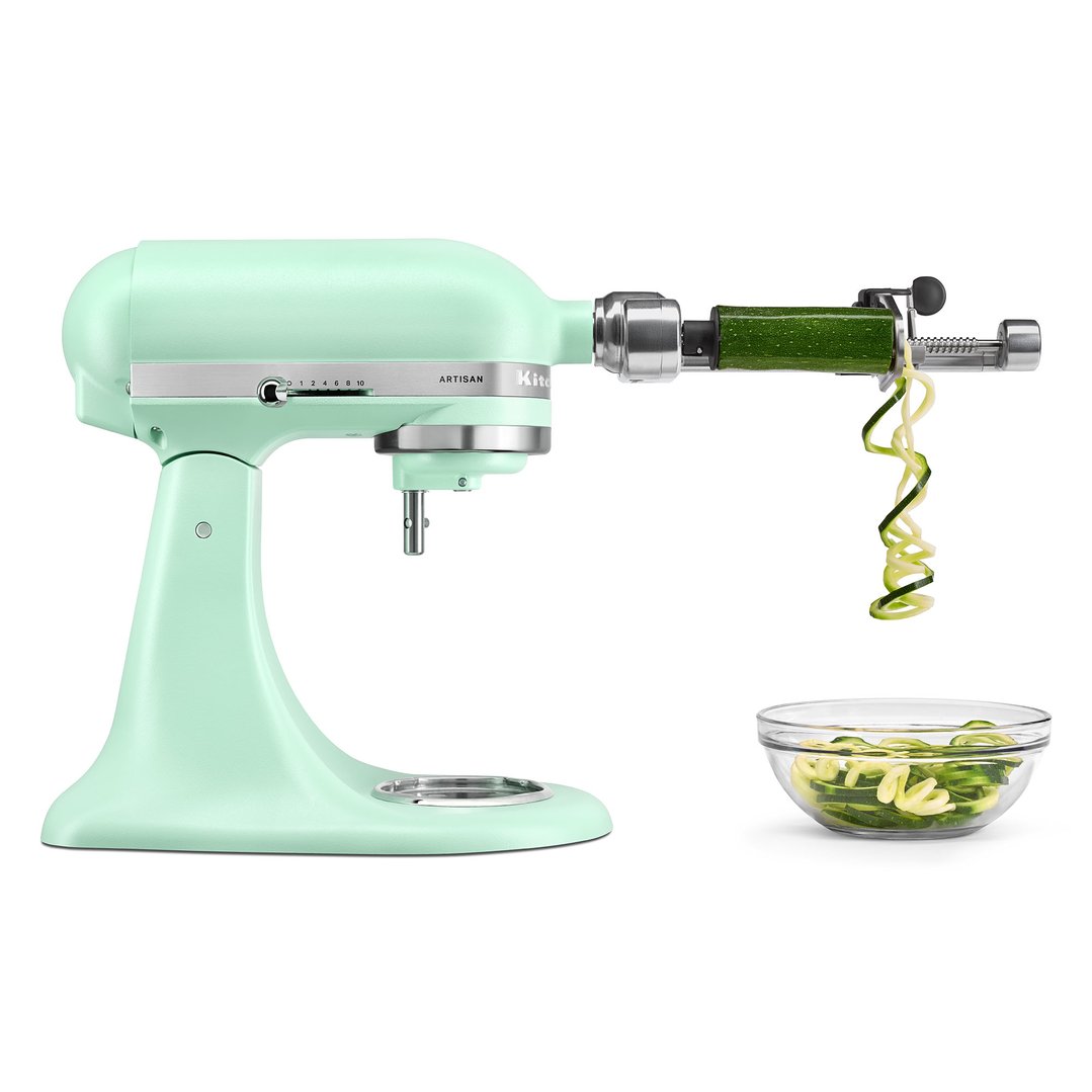 Spearmint stand mixer with spiralizer attachment making zucchini noodles into a glass bowl