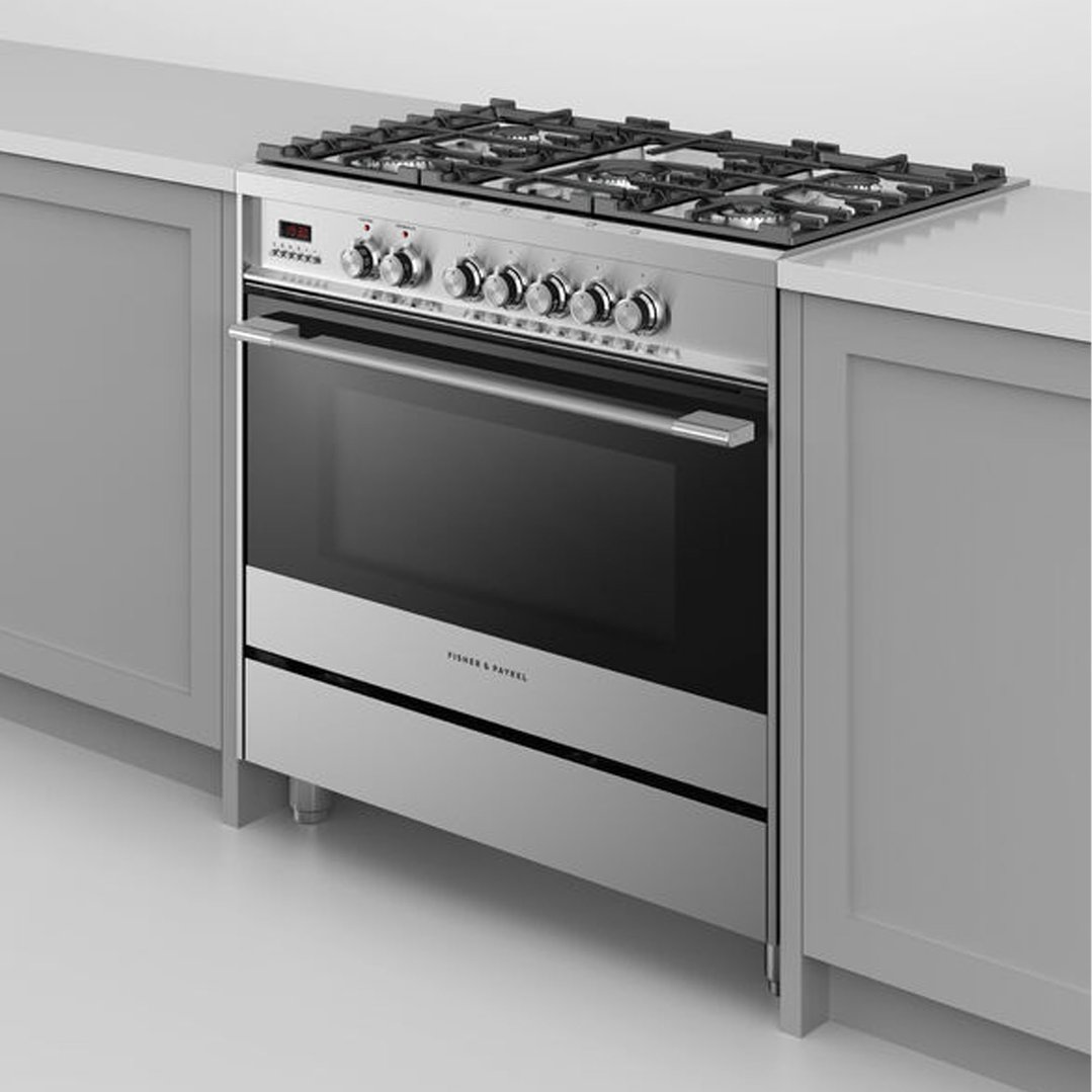 A stainless steel dual fuel cooker with a gas hob and oven in a kitchen setting