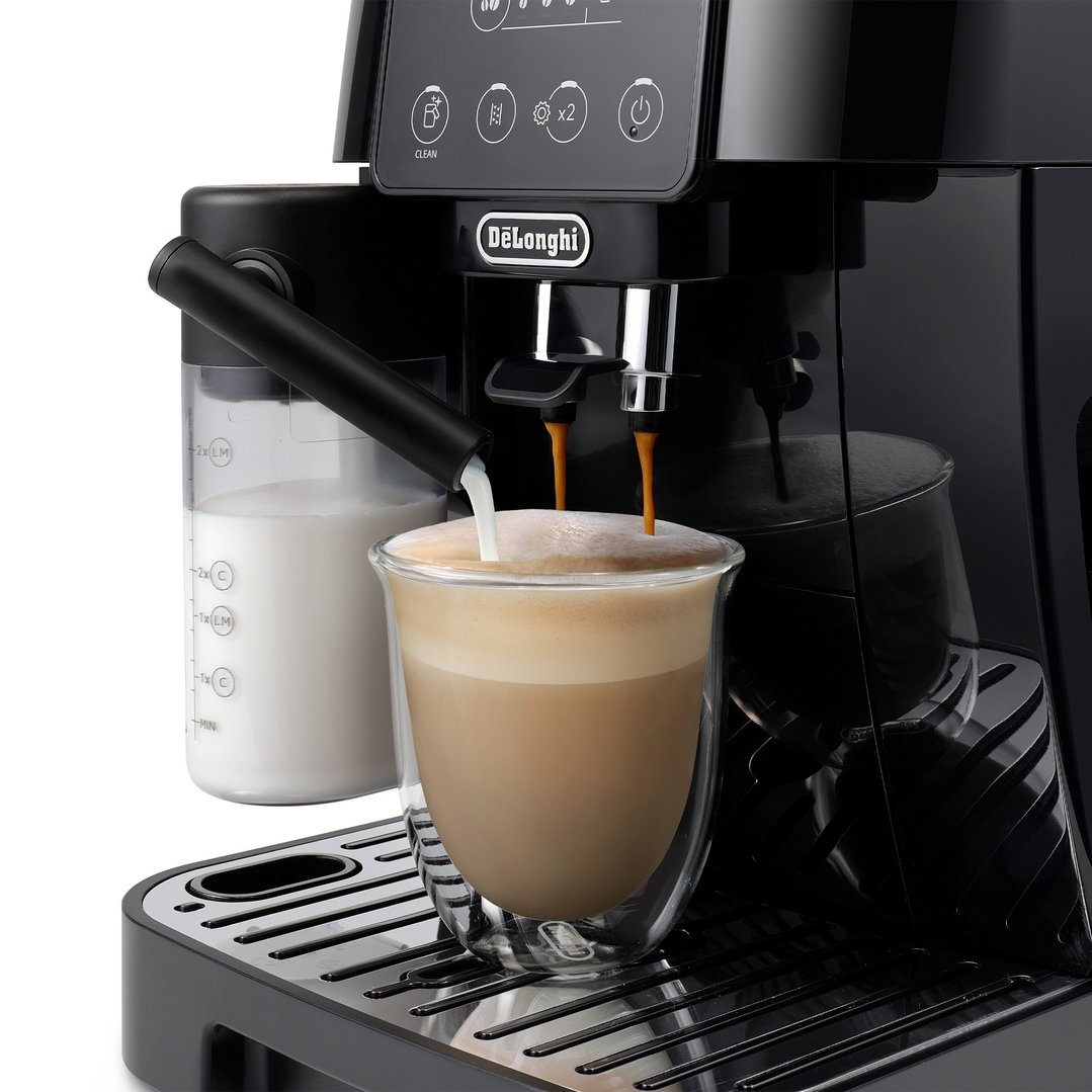 Black coffee machine dispensing coffee and milk into a glass