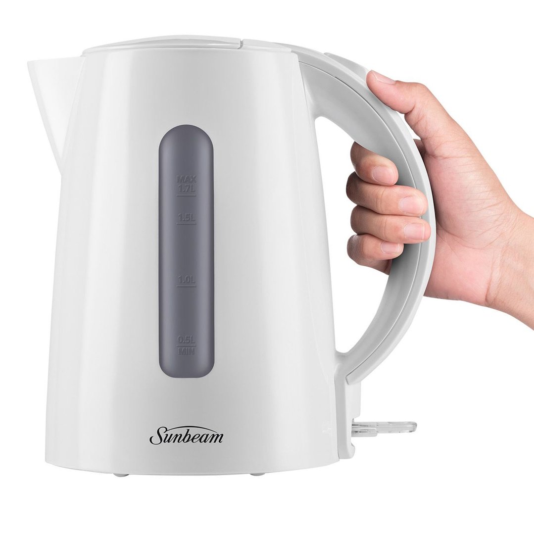 Hand holding a white Sunbeam kettle with a water level indicator