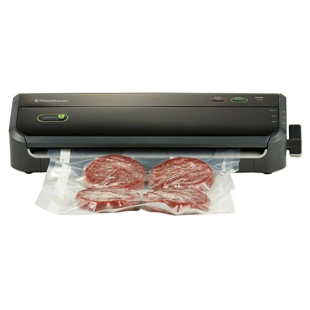 FoodSaver vacuum sealer sealing four portions of meat in a plastic bag