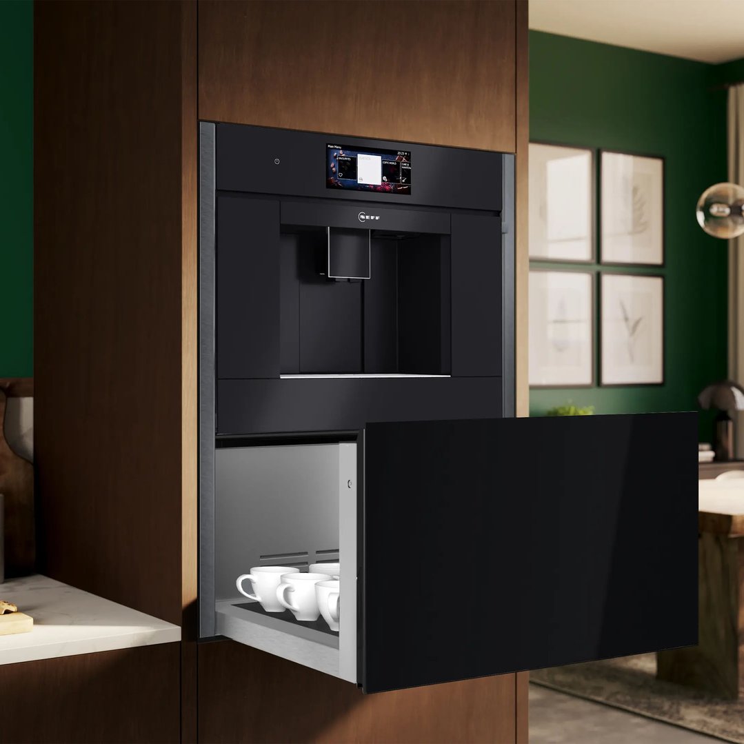 Built-in coffee machine and warming drawer in a modern kitchen setting