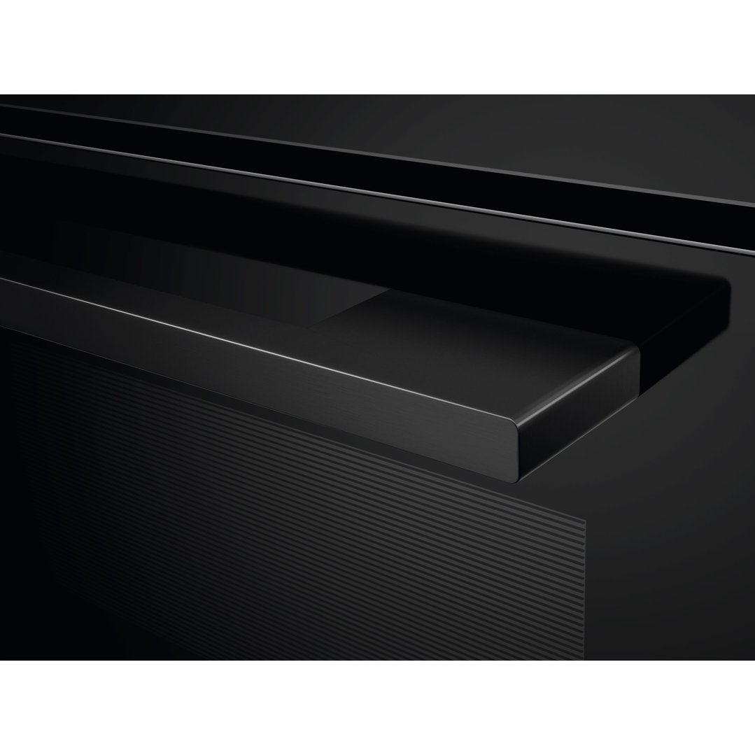 Close up of the black oven handle and textured surface