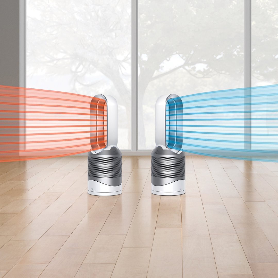 Two Dyson air purifiers in a room, one emitting hot air, one cool air