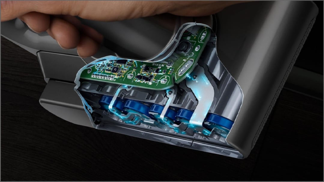 Close up of a hand holding a Dyson handstick vacuum with internal components visible