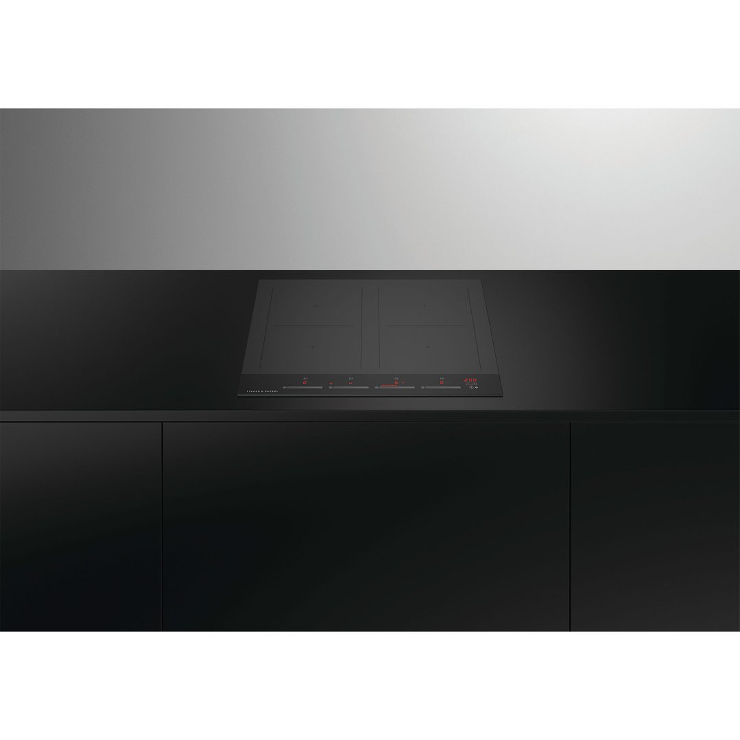 Black induction cooktop with red digital display built into a dark kitchen counter