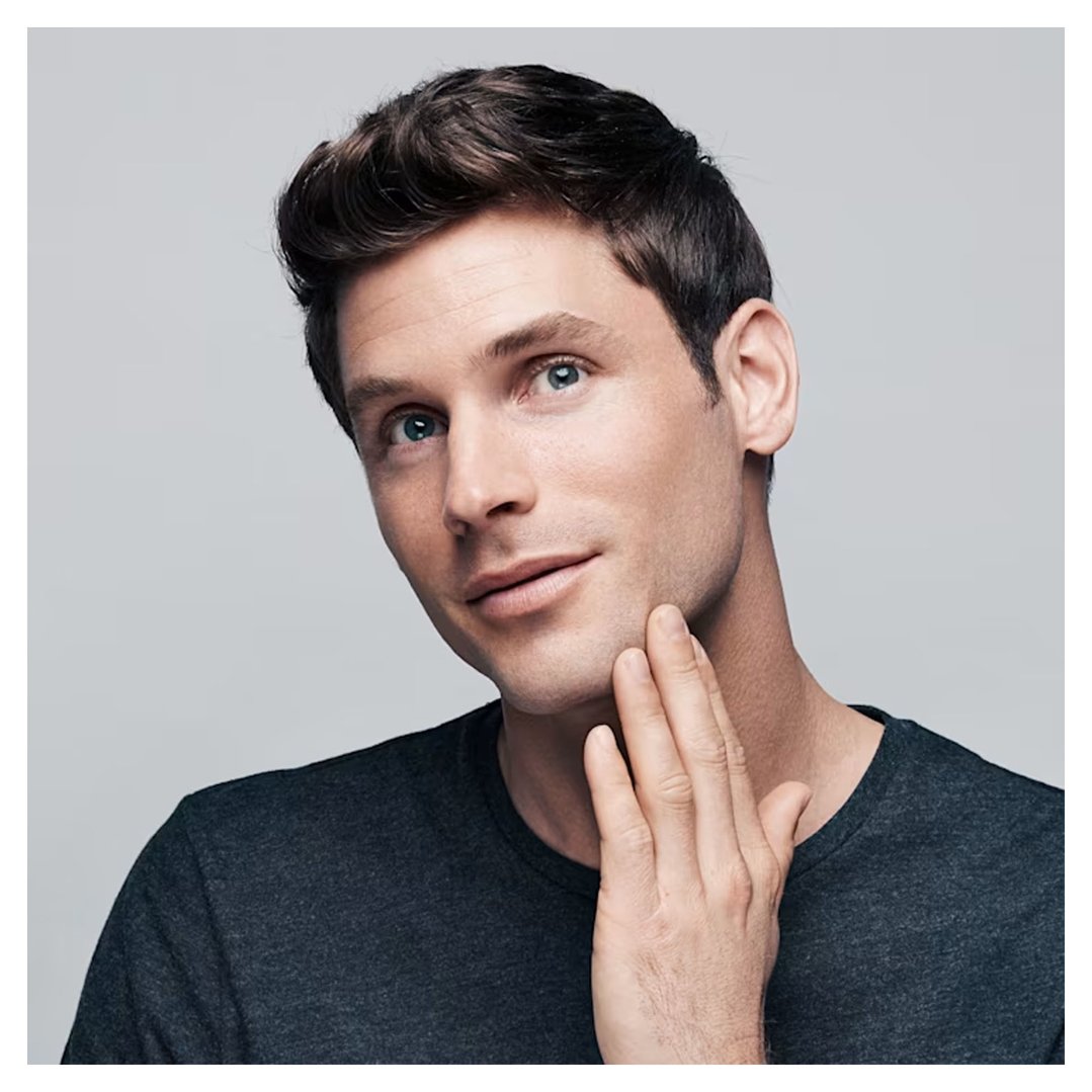 Man touching his jawline, looking up and to the right